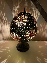  Decorative gourd lamp with intricate floral cutout pattern, creating a warm, ambient lighting effect.