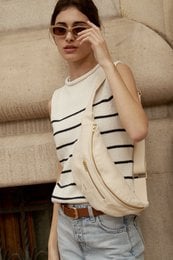 Beige shoulder bag with striped pattern and leather detailing.