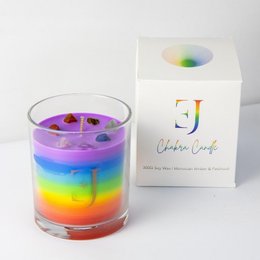 Chakra 'feel good' candle, a colorful, layered candle with a rainbow design. Made of natural soy wax and infused with essential oils for a calming, uplifting scent.