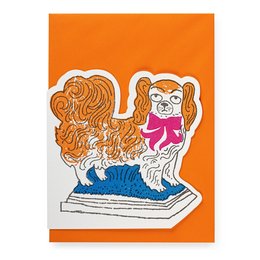 Archivist Cards Cut Out Card - Pekingese. This card features a colorful illustration of a Pekingese dog with long, flowing orange fur. The dog is sitting on a blue surface, creating a whimsical and playful design.