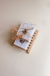 Handmade bamboo and birch soap holders, featuring a delicate floral arrangement. The soap holders come in a gift pack with a 10% discount.