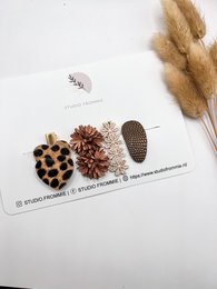 Decorative hair clips featuring leopard print and floral designs, suitable for kids.