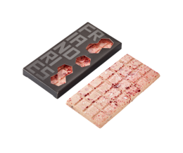 A rectangular chocolate bar with raspberry, yogurt, and cacao nibs. The chocolate bar is dark in color and has visible pieces of raspberry and cacao nibs embedded in it.