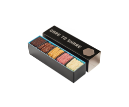 Assorted colorful macarons in a gift box. The macarons feature various pastel colors including pink, yellow, green, and blue. The box is black with the text "Friandries Galetjes" printed on it, indicating this is a gift box of macarons.