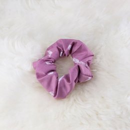 Pink feather-embellished scrunchie hair accessory