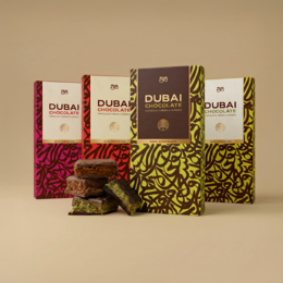  "Luxury Dubai chocolate assortment box, gold and burgundy packaging, premium gift set with multiple chocolate varieties"