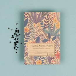 A colorful, nature-inspired birthday card with a floral and leaf pattern design. The card can be planted after use to grow wildflowers.