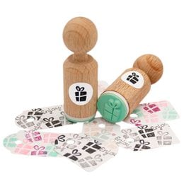 A festive Christmas gift mini stamp with a present design, made of wood. Includes various rubber stamp shapes like paw prints and hearts.
