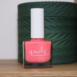 Vibrant coral nail polish with a glossy finish.