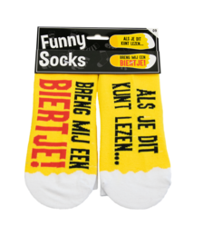 White socks with yellow polka dots and text "Bring me a beer" printed on them.