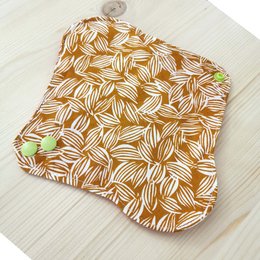 Washable sanitary towel with an abstract floral pattern in shades of brown and white.