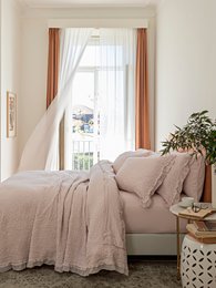 Premium jacquard coverlet in pale blush and white colors, available in queen and king sizes, featuring a soft, textured material.