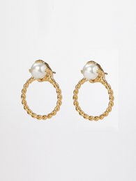 Round small post hoop earrings set with a pearl, 24K yellow gold plated, in a classic fine look.
