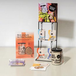  The product appears to be a set of gift cards and pendants related to baking and cooking. The key details that can be extracted from the images and product information are:

Colors: The product packaging features a variety of colors including orange, pink, and white.
Materials: The product includes items made of glass, metal, and paper.
Style: The design has a handmade, artisanal aesthetic.
Shapes: The pendants feature various shapes like hearts and text.
Texts: The product includes text such as "Favorite knifts", "Bio-joy tears", "bread & salt", and "all the best".
Imagery: One of the product images shows a jar with a label that includes an illustration of a person.

This information could be used to improve the searchability of the product on an ecommerce platform, allowing customers to find it based on relevant keywords and attributes.