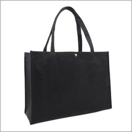 Large black felt shoulder bag with sturdy handles.