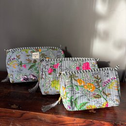 Grey cotton toiletry pouch with colorful floral print, available in small, medium, and large sizes.