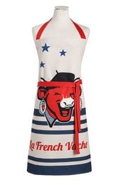 "Patriotic apron featuring the iconic French Vache character in red, white, and blue design. Includes stars and stripes pattern."