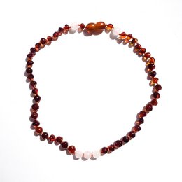 Amber baby necklace with natural, irregular-shaped amber beads in shades of brown, orange, and red. The necklace features a clasp and is designed for unconditional love.