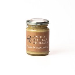 Creamy almond spread in a glass jar with a label featuring the Antica Ricetta Siciliana brand name.