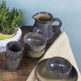 Ocher glazed ceramic medium-sized serving bowl with a rustic, earthy appearance.