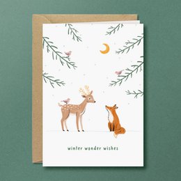 "Charming Christmas card featuring woodland animals in a snowy forest scene. Includes a deer and a fox with the text 'winter wonder wishes'."