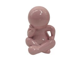  "Mauve ceramic sitting figure statue, round head, cross-legged pose, glossy finish, decorative home accent"