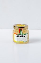 A small glass jar of rosemary-infused honey. The honey has a golden color and is labeled "Martine Rosemary Honey 60gr".
