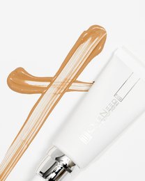 A white and gold tube of P.02 Perfection.honey cream with a smooth, creamy texture and a simple, minimalist design.
