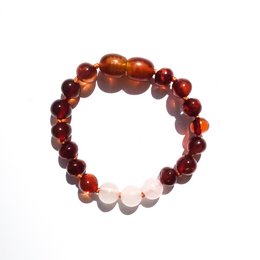 Baltic natural amber baby bracelet/anklet with unconditional love design. Features round amber beads in shades of orange and red.