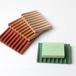 Rectangular soap holder in off-white, terracotta, red, and green colors with a minimalist line design.