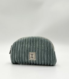 A mint green corduroy vanity bag with a waterproof interior, perfect for storing makeup and other essentials.