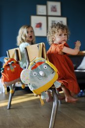 Colorful elephant-shaped backpack with playful design, suitable for young children. Features a gray elephant body, yellow accents, and whimsical details.