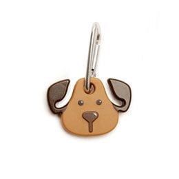 A brown and tan dog-shaped poop bag holder with a green leash attached.