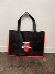 Black tote bag with red trim and a red coffee cup logo design. Durable and spacious for shopping or everyday use.
