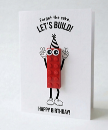  Red Lego brick character birthday card with "Let's build" text, happy birthday greeting, playful design