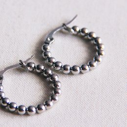 Stainless steel creole hoop earrings with 20mm "balls" in a silver color. The earrings feature a circular hoop design with small beads or balls evenly spaced around the hoop.