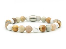 Natural beaded bracelet with varying bead sizes and colors including white, brown, and gray tones.