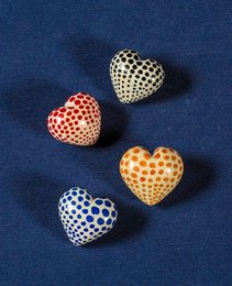 Soapstone heart-shaped statues with polka dot patterns in various colors including red, yellow, and blue.