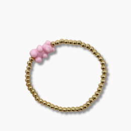 A delicate gold-colored beaded bracelet with a small white charm, perfect for kids.