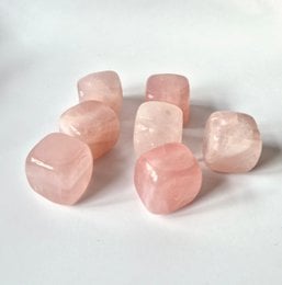  Small, cube-shaped rose quartz crystals, approximately 2-3cm in size.