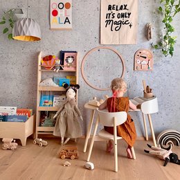 A modern, minimalist kids table with a light wood top and white metal legs. Suitable for a playroom or child's bedroom.