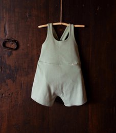 Cotton overall jumpsuit for kids in various colors including cotton flower, cinnamon, acorn, and thyme. Features a relaxed, comfortable fit for active play.