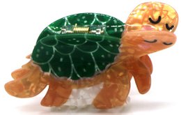  Trendy hair claw in the shape of a turtle, measuring 8.5cm. Made of durable materials in a vibrant green and orange color scheme.