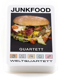 A large, savory hamburger with multiple layers of ingredients including a bun, patty, cheese, lettuce, and other toppings. The product is labeled as "Junkfood Quartett" and appears to be a game or puzzle related to unhealthy food.