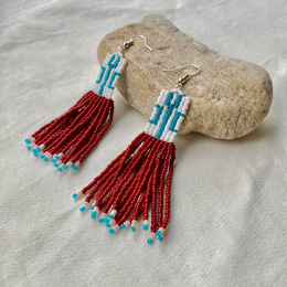  Handmade statement earrings with long red and turquoise beaded fringe, featuring a unique and bohemian style.