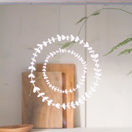 Botanical reusable window stickers in black and white, featuring a wreath-like design with leaf-shaped elements. The stickers can be used to decorate windows, walls, or other surfaces.