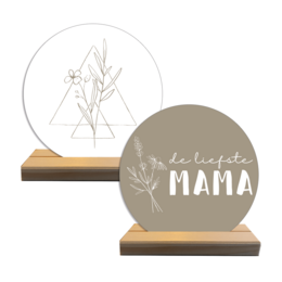 Decorative object with floral design and text "The sweetest mama" in a round frame.