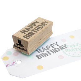 A wooden stamp with the text "Happy Birthday" in a simple, bold font. The stamp appears to be made of natural wood material and is designed for stamping birthday messages or decorations.