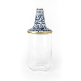 A short, round glass vase with a blue and white floral pattern on the exterior.