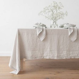 Linen tablecloth in a light stone-washed color, available in various rectangular and round sizes.